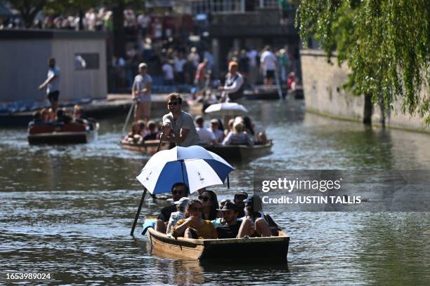 People enjoy the sunshine while punting on the River Cam in Cambridge, north of London on September 9 as the late summer heatwave continues.