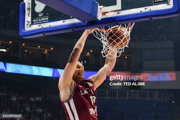 Latvia's Klavs Cavars dunks during the FIBA Basketball World Cup final classification 5-6 match between Latvia and Lithuania in Manila on September...