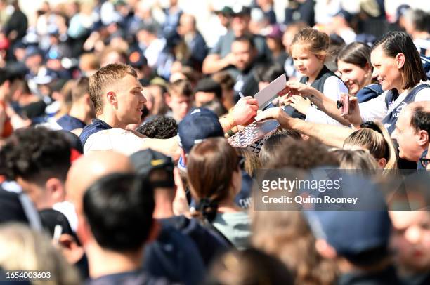 Patrick Cripps of the Blues signs autographs for fans during a Carlton Blues AFL training session at Ikon Park on September 02, 2023 in Melbourne,...