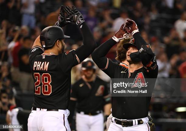 Christian Walker of the Arizona Diamondbacks celebrates with Tommy Pham after hitting a two-run home run against the Baltimore Orioles during the...