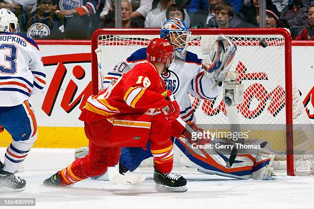 Matt Stajan of the Calgary Flames scores against Devan Dubnyk of the Edmonton Oilers on April 3, 2013 at the Scotiabank Saddledome in Calgary,...