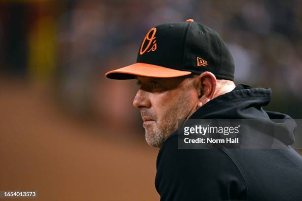 Manager Brandon Hyde of the Baltimore Orioles looks on from the dugout during the fifth inning against the Arizona Diamondbacks at Chase Field on...