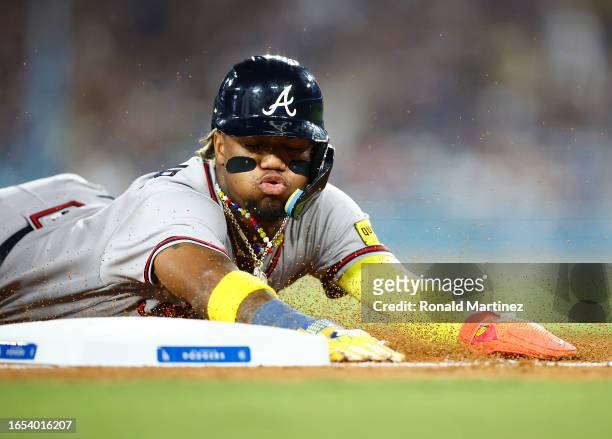 Ronald Acuna Jr. #13 of the Atlanta Braves steals third base against the Los Angeles Dodgers in the fifth inning at Dodger Stadium on September 01,...