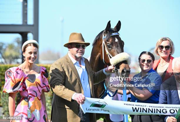 Trainers Katherine Coleman and Peter Moody pose after Nunthorpe won Race 3, the Fierce Impact - Pedigree Performance, during Melbourne Racing at...