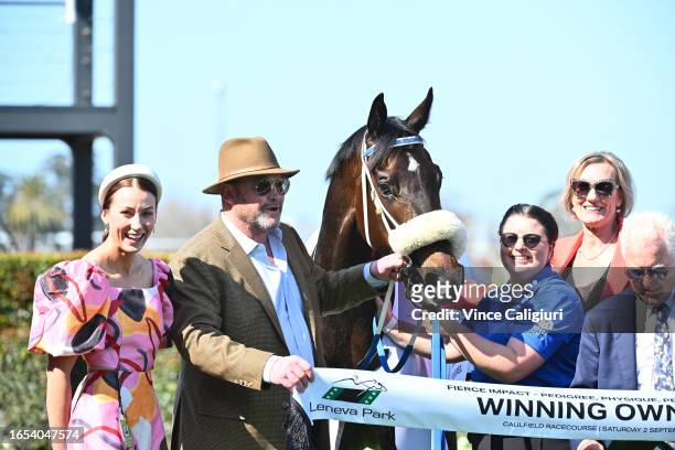 Trainers Katherine Coleman and Peter Moody pose after Nunthorpe won Race 3, the Fierce Impact - Pedigree Performance, during Melbourne Racing at...