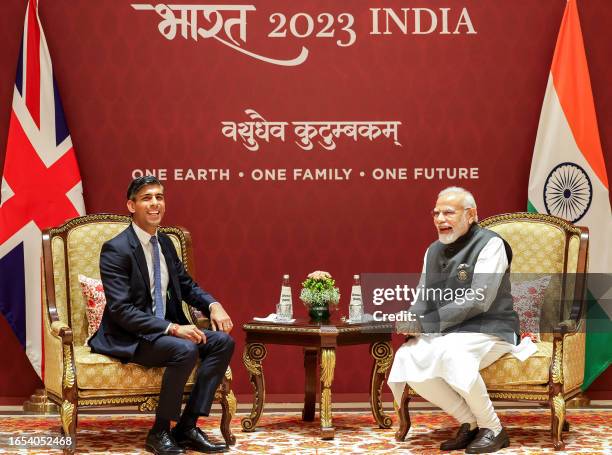 India's Prime Minister Narendra Modi speaks with his Britain counterpart Rishi Sunak during a bilateral meeting on the first day of the G20 Summit in...