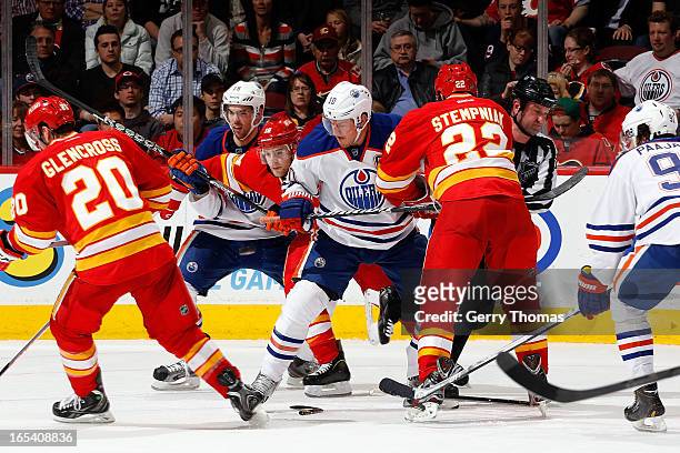 Lee Stempniak and Matt Stajan of the Calgary Flames skate against Shawn Horcoff and Justin Schultz of the Edmonton Oilers on April 3, 2013 at the...