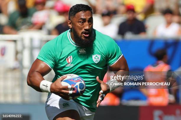 Ireland's inside centre Bundee Aki runs with the ball during the France 2023 Rugby World Cup Pool B match between Ireland and Romania at Stade de...
