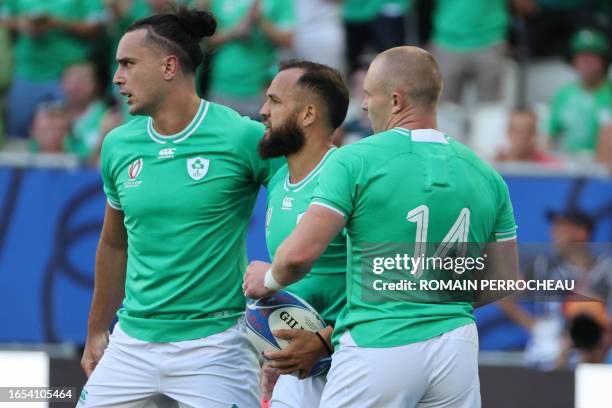 Ireland's wing James Lowe and Ireland's wing Keith Earls celebrate with Ireland's scrum-half Jamison Gibson-Park after he scored a try during the...