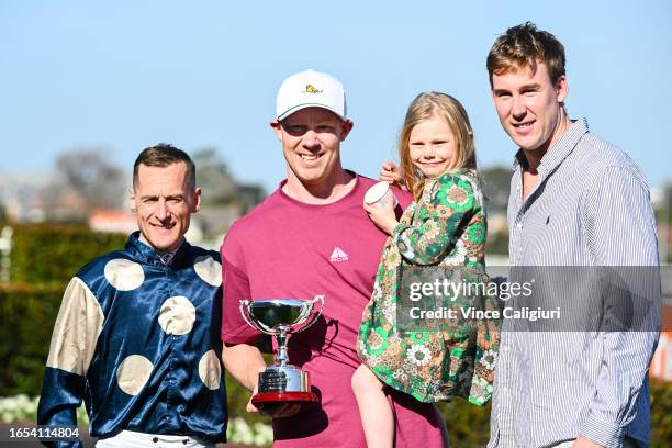 Winning connections Jack Riewoldt and daughter Poppy Riewoldt and Tom Lynch pose with Blake Shinn after Soulcombe won Race 6, the Tile Importer...