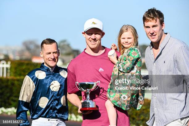 Winning connections Jack Riewoldt and daughter Poppy Riewoldt and Tom Lynch pose with Blake Shinn after Soulcombe won Race 6, the Tile Importer...