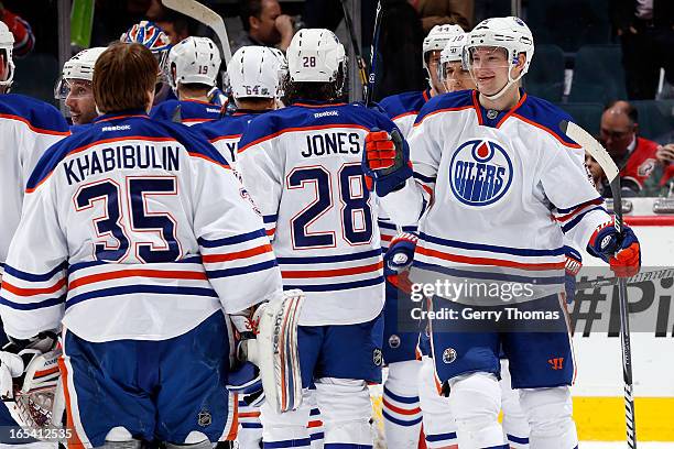 Ladislav Smid, Ryan Jones and teammates of the Edmonton Oilers celebrate a win against the Calgary Flames on April 3, 2013 at the Scotiabank...