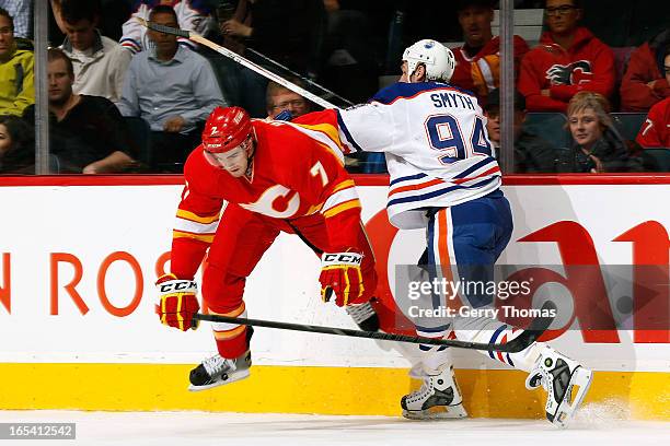 Brodie of the Calgary Flames skates against Ryan Smyth of the Edmonton Oilers on April 3, 2013 at the Scotiabank Saddledome in Calgary, Alberta,...