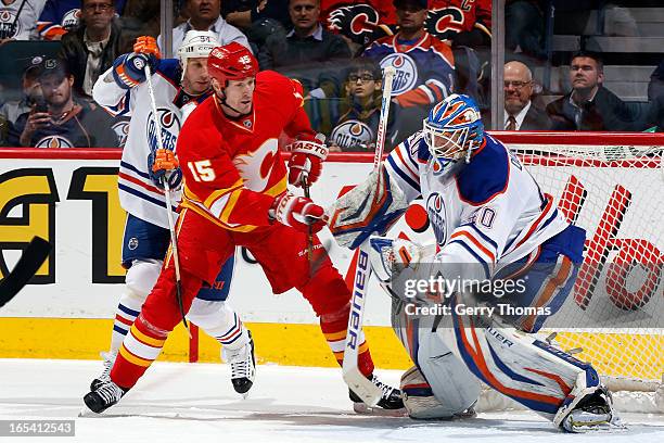 Tim Jackman of the Calgary Flames looks for a rebound against Devan Dubnyk of the Edmonton Oilers on April 3, 2013 at the Scotiabank Saddledome in...