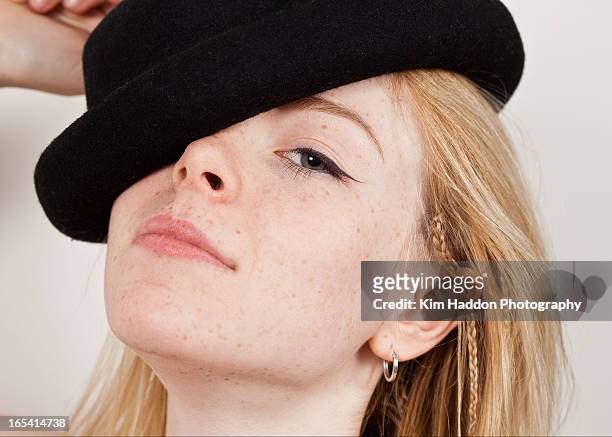 tilted portrait of pretty young blonde lady - close up of beautiful young blonde woman with black hat stock pictures, royalty-free photos & images