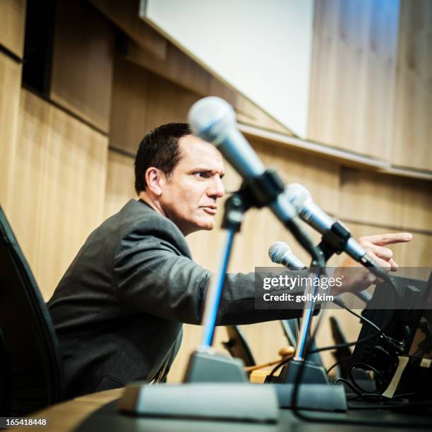 displeased politician at auditorium - angry politician stock pictures, royalty-free photos & images