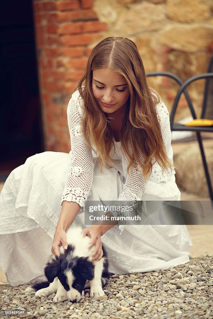 Girl playing with puppy