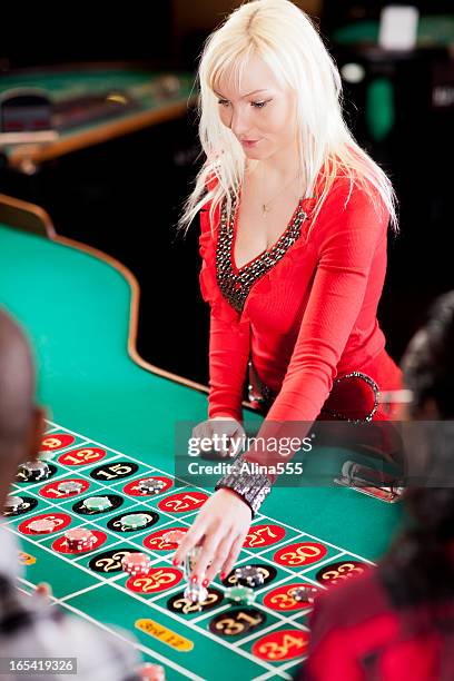 casino dealer at the roullete table - roulette croupier stock pictures, royalty-free photos & images