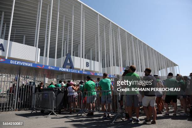 Ireland's supporters queue to enter the stadium ahead of the France 2023 Rugby World Cup Pool B match between Ireland and Romania at Stade de...