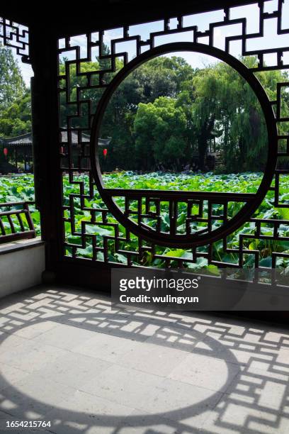 lotus pond's view through the pavilion window - water lily stock pictures, royalty-free photos & images