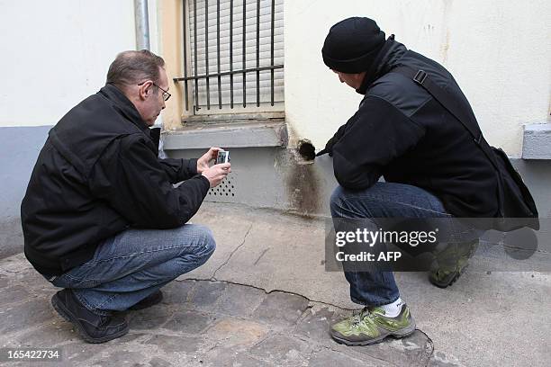 Police officers looks for rats, on April 3, 2013 in Paris' 18th district. Paris Prefecture of Police's nuisance animals prevention unit, founded in...