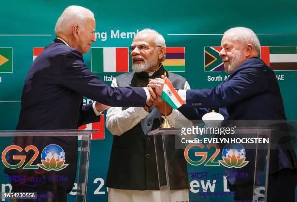 President Joe Biden , Indian Prime Minister Narendra Modi and Brazil's President Luiz Inacio Lula da Silva hold hands during the launch of the Global...