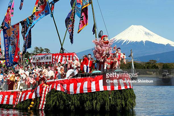 Fishermen and boys dressed and make-up as women dance on a decorated boat during annual Ose Festival at Suruga Bay on April 4, 2013 in Numazu,...