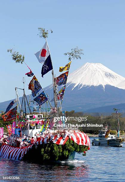 Fishermen and boys dressed and make-up as women dance on a decorated boat during annual Ose Festival at Suruga Bay on April 4, 2013 in Numazu,...