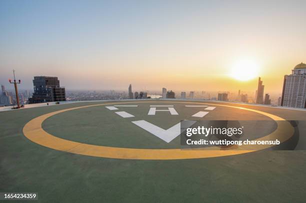 helipad on the roof of skyscraper with twilight sky scene in the cityscape, - helipad stock pictures, royalty-free photos & images