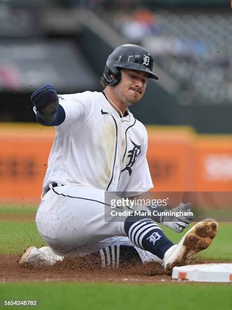Zach McKinstry of the Detroit Tigers slides safely into third base during the game against the Chicago Cubs at Comerica Park on August 23, 2023 in...