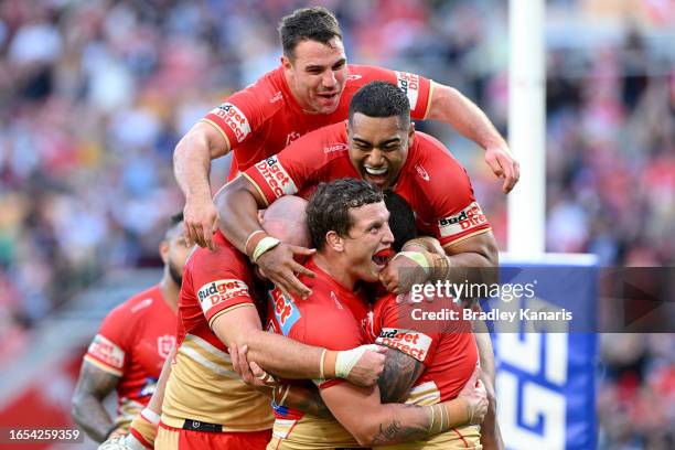 Kenny Bromwich of the Dolphins is congratulated by team mates after scoring a try during the round 27 NRL match between the Dolphins and New Zealand...
