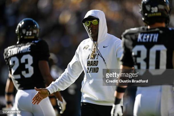 Head coach Deion Sanders of the Colorado Buffaloes walks and greets players as they warm up before a game against the Nebraska Cornhuskers at Folsom...
