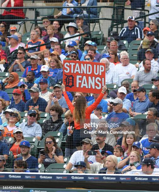 Member of the Comerica Park Energy Squad holds up a sign to fire-up the crowd during the game between the Chicago Cubs and the Detroit Tigers at...