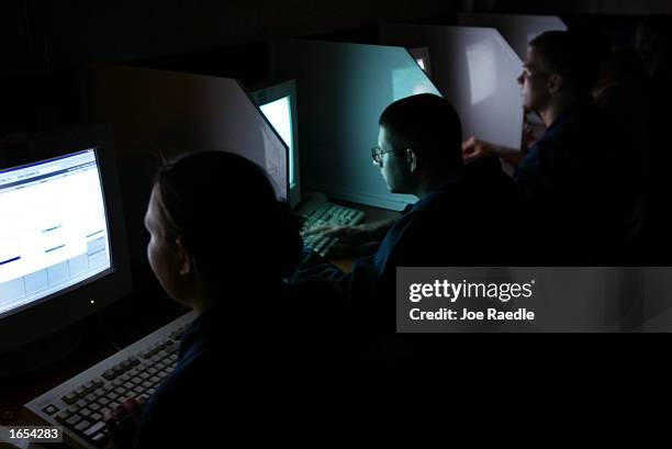 Sailors aboard the USS Fletcher use email to stay in touch with friends November 19, 2002 in the Persian Gulf. The ship is part of the U.S. Navy...