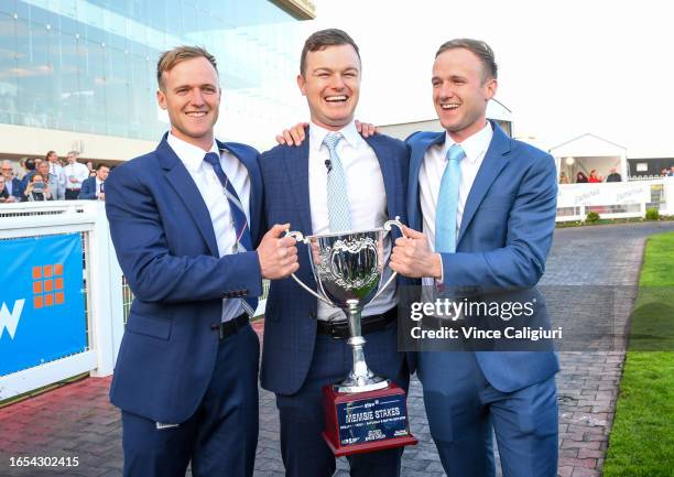 Trainers Will Hayes, Ben Hayes and JD Hayes pose with trophy after Mr Brightside won in Race 9, the Stow Storage Memsie Stakes, during Melbourne...