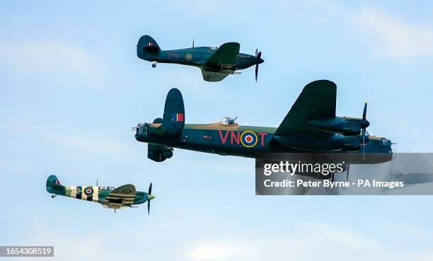 Spitfire, a Hawker Hurricane, and a Lancaster bomber, part of the Battle of Britain Memorial Flight, during the annual Southport Air Show at...