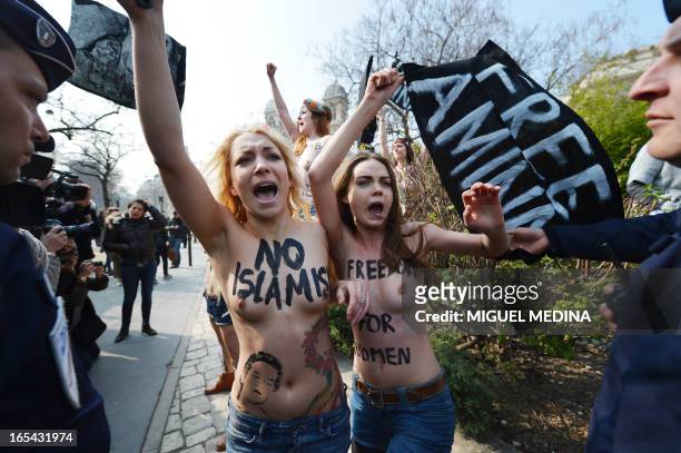 Ukrainian activist Inna Shevchenko of the women's rights movement Femen takes part in a topless protest with other Femen activists near Tunisia's...