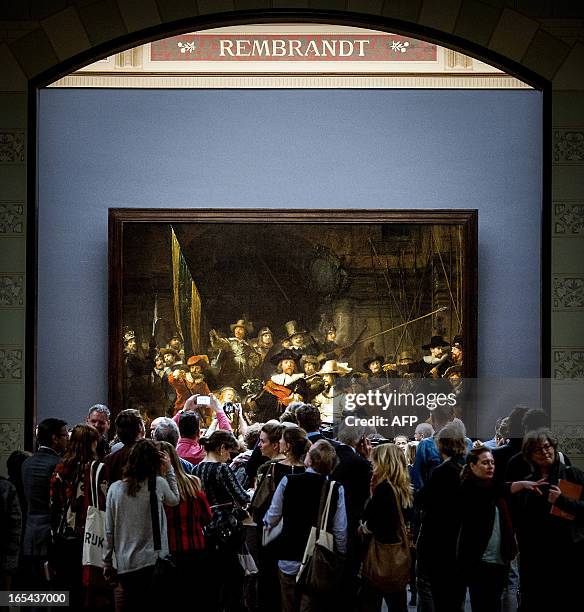 Visitors admire Rembrandt's "The Night Watch" during press-viewing day at he Rijksmuseum in Amsterdam on April 4, 2013. Amsterdam's world-famous...