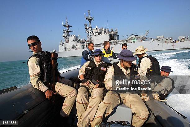 Navy sailors from the USS Fletcher ride in a rib boat as they prepare to inspect oil tankers that are being filled from an Iraqi oil platform...