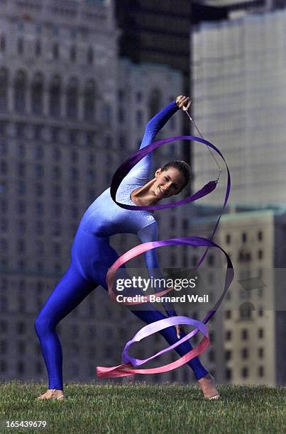 Emilie Livingston, Olympic rythmic gymnast, is framed by the Toronto skyline while posing with her ribbon. For Olympic poster series