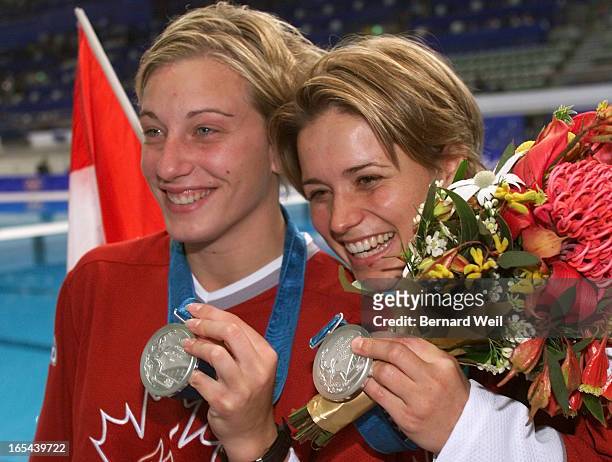 Emilie Heymans, left, and Anne Montminy display their silver medals after the Women's Synchronized 10m Platform Final competition during the 2000...
