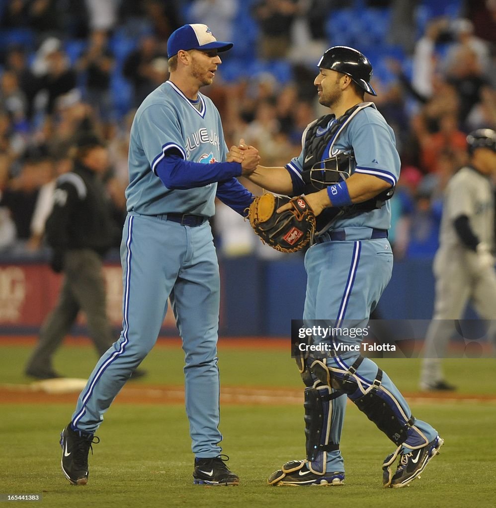 09/25//09 - Toronto Blue Jay Roy Halladay gets congratulated by catcher Rod Barajas and other teamat