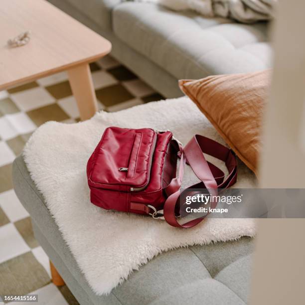 modern hand bag lying on sofa at home - handväska bildbanksfoton och bilder