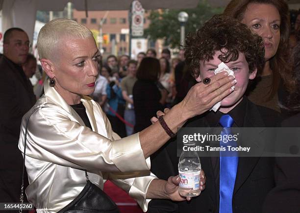 September 7, 2001 Irina, mother of Anton Yelchin wipes the shine off her son's face as they arrive at Roy Thompson Hall for the premiere of Hearts in...