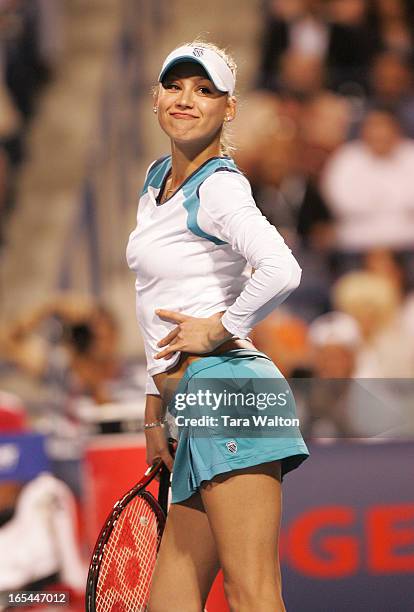 Tennis Legend Anna Kournikova strikes a pose for fans in Toronto during a friendly doubles match with partner John McEnroe against Jim Courier and...