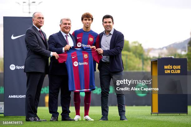 Joao Felix poses with First Vice President Rafael Yuste, President Joan Laporta and Sporting Director Anderson Luis de Souza 'Deco' as he is unveiled...