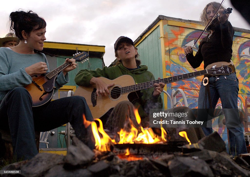 NWT-Yellowknife-June 8, 2005-(center) Brodie Dawson, 30, sings round the campfire while playing on h