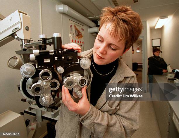 Nurse Kate Neil checks out eye examination equipment in foreground as nurse Cristine Moorhouse works in background aboard the Eye Van, a transport...
