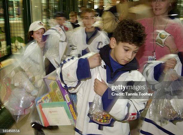 Dec.8,2001-Manny Gialedakis carries a big bag of Christmas presents along with each of his Novice triple A Toronto Marlboro teammates to donate them...