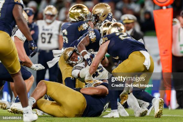 Daba Fofana of Navy Midshipmen is tackled during the Aer Lingus College Football Classic match between Notre Dame and Navy at Aviva Stadium on August...